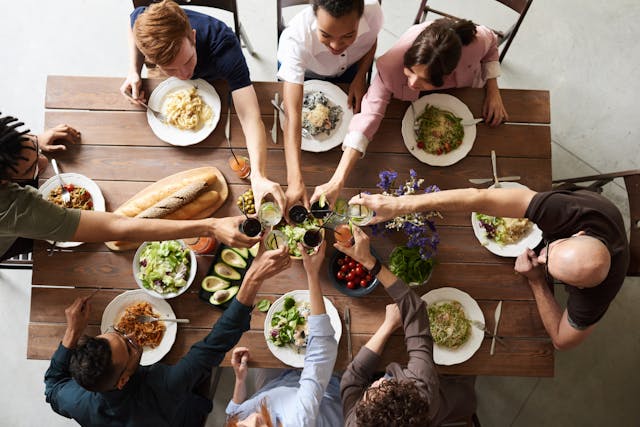 Adults on a food tour at table with food and drinks