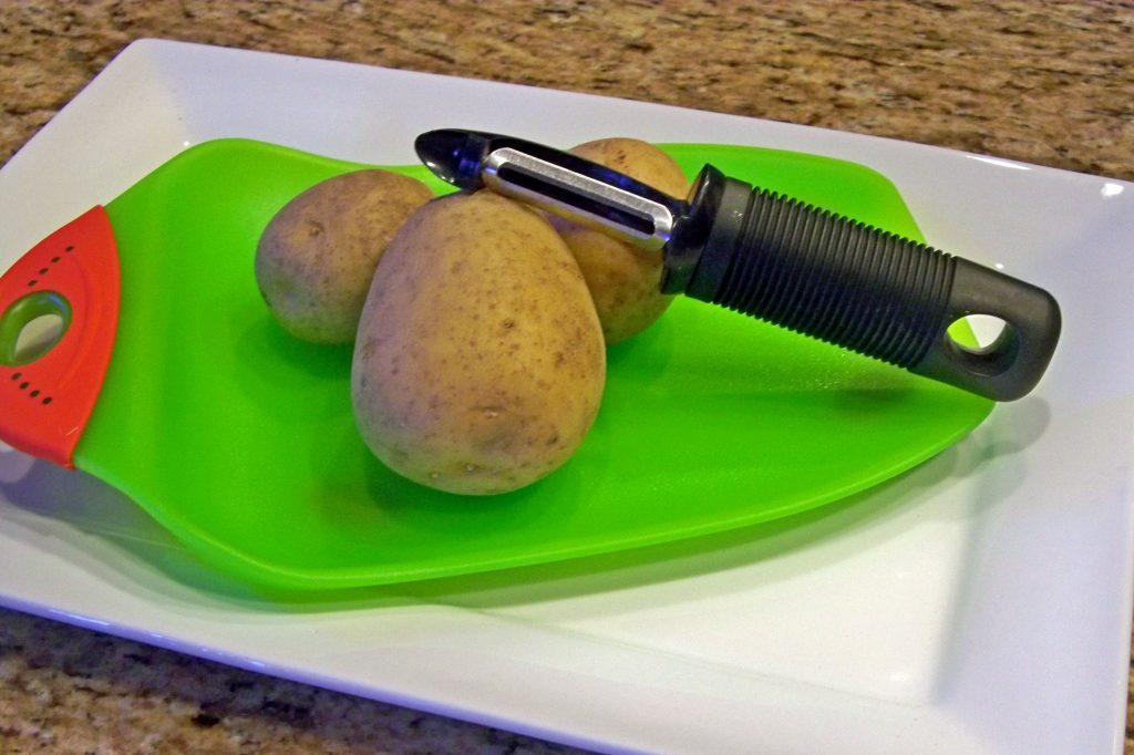 vegetable peeler, potatoes, cutting board, kitchen tools, dish dish, dishdish, recipes