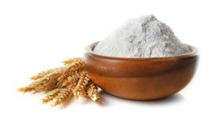 wheat flour in bowl with wheat stalks