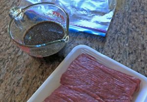 Stir fry beef strips and marinade for beef jerky